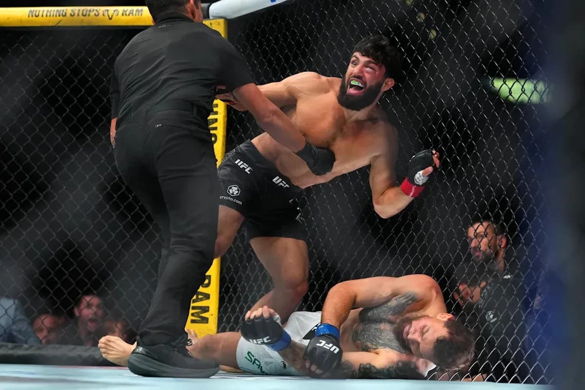 Fighter celebrating after winning match in octagon Fighter celebrating after winning match in octagon