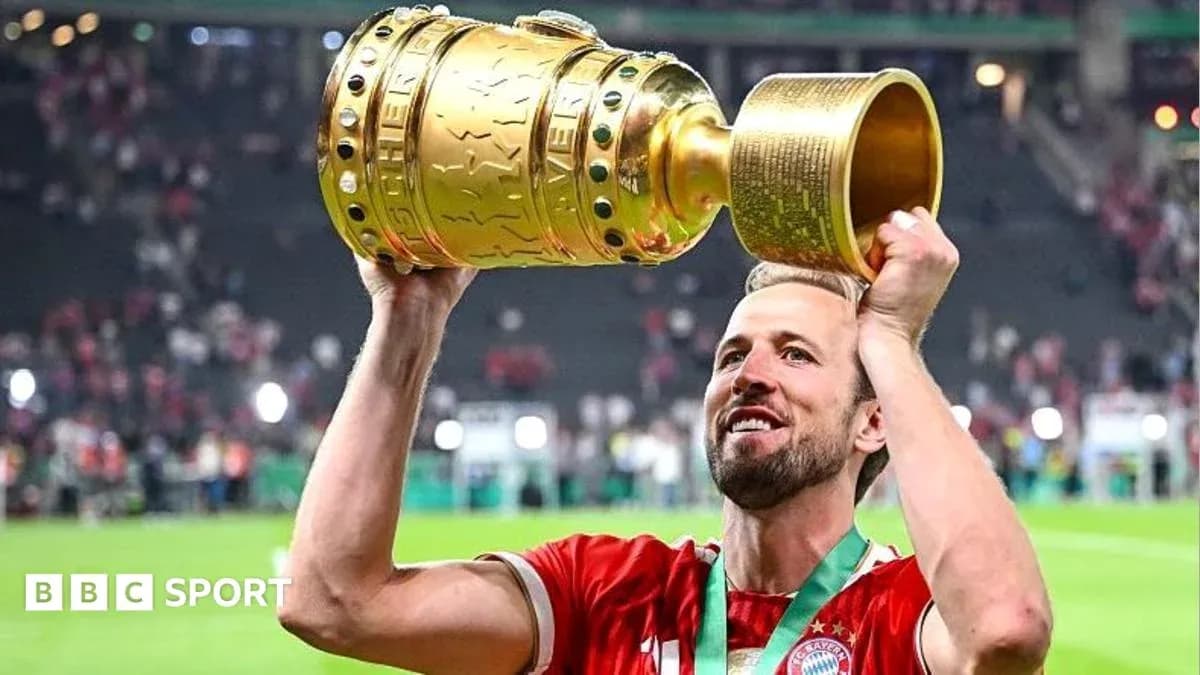 Player celebrating with trophy after match victory Player celebrating with trophy after match victory