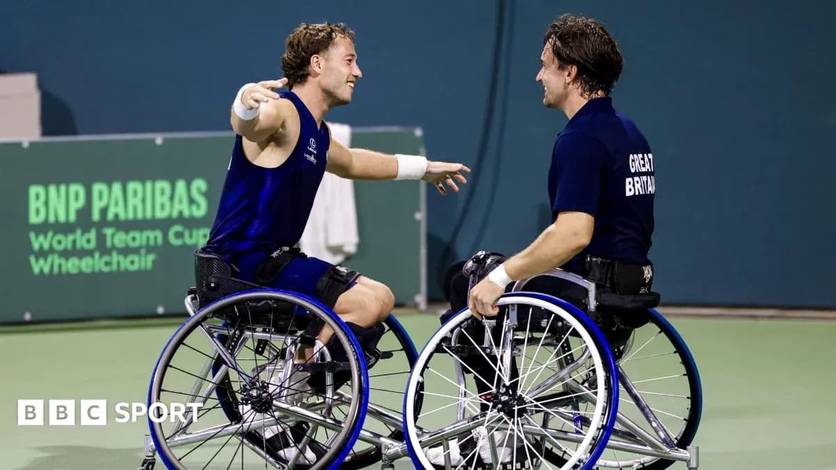 Two wheelchair tennis players celebrating on court Two wheelchair tennis players celebrating on court