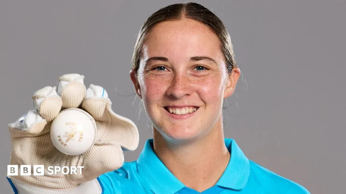 Cricketer holding a ball and smiling Cricketer holding a ball and smiling